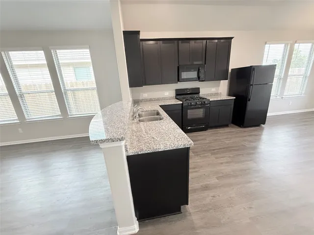 a kitchen with stainless steel appliances a counter top space and a window