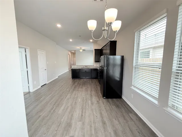 a view of kitchen with refrigerator and window
