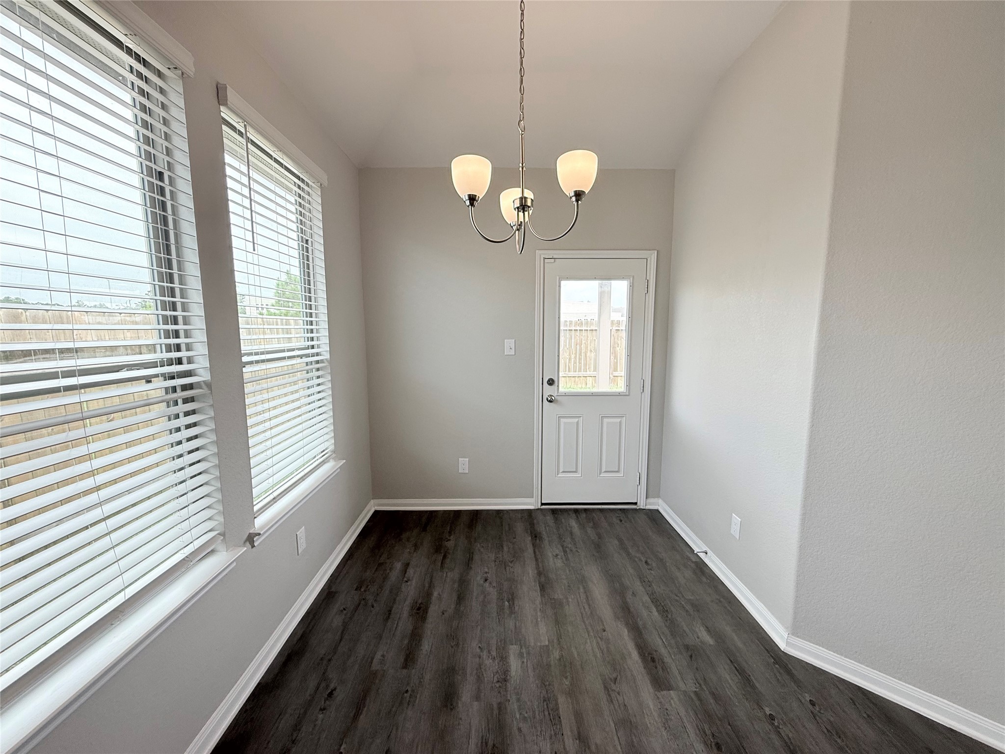 14501 Sugar Pines Drive Conroe, TX 77302 - Photo 19 of 46 a view of a room with wooden floor and windows