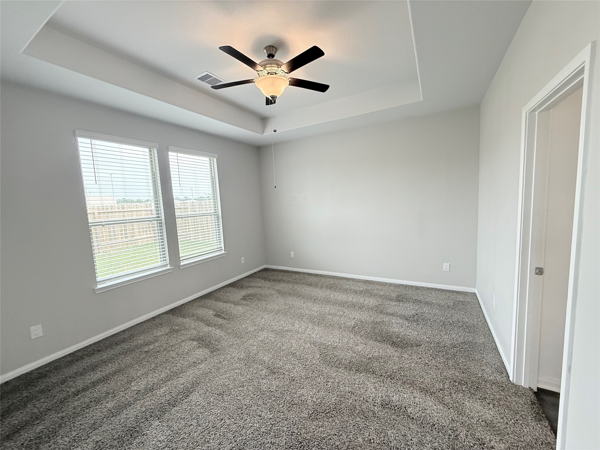 14501 Sugar Pines Drive Conroe, TX 77302 - Photo 24 of 46 an empty room with windows and ceiling fan