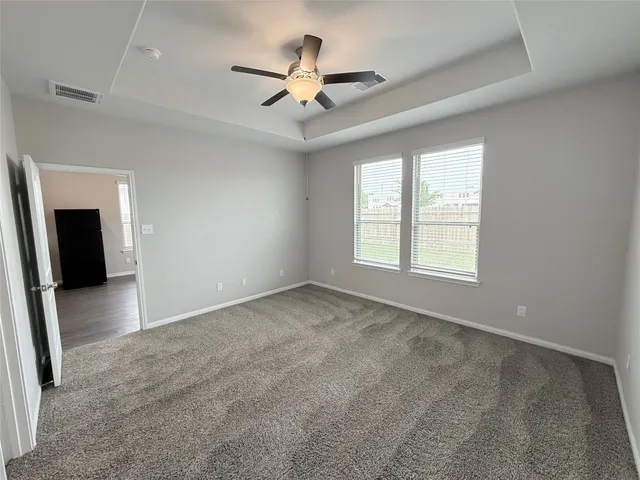 an empty room with closet and windows