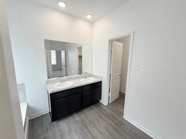 a bathroom with a granite countertop sink mirror and toilet