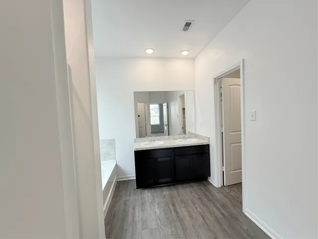 a view of room with wooden floor and window