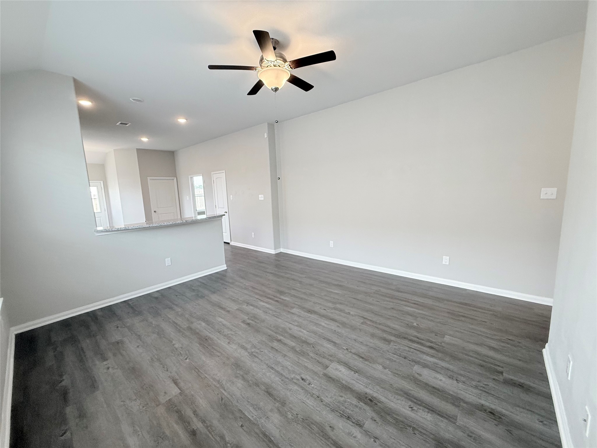 14501 Sugar Pines Drive Conroe, TX 77302 - Photo 10 of 46 an empty room with wooden floor and windows