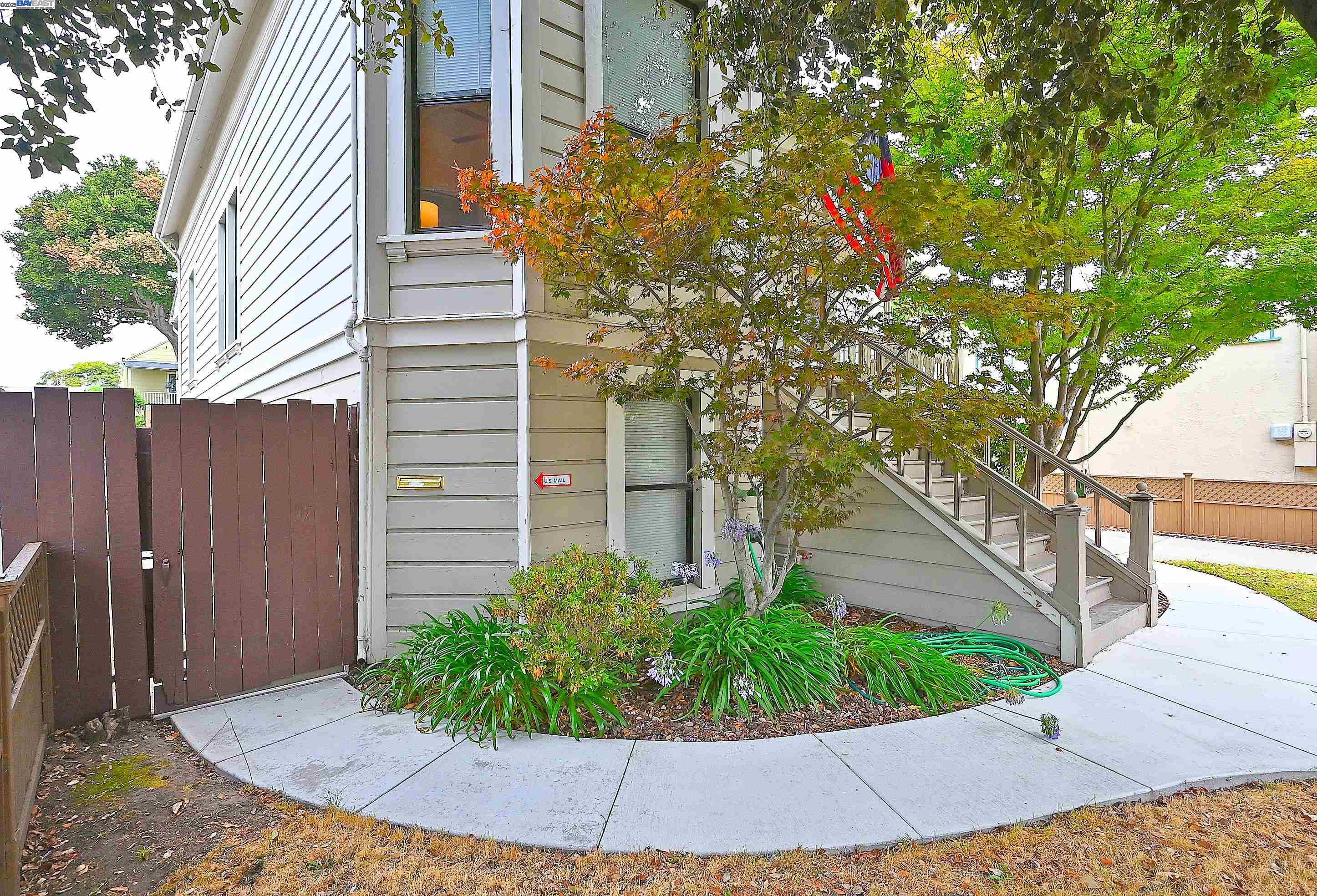 1613 Union Street Alameda, CA 94501 - Photo 2 of 28 a view of a house with a small yard and plants