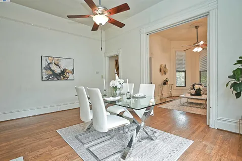 a living room with dining table and a wooden floor
