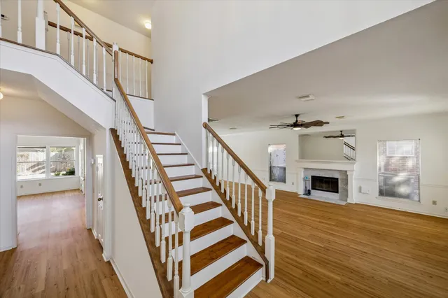 a view of a livingroom with wooden floor and stairs