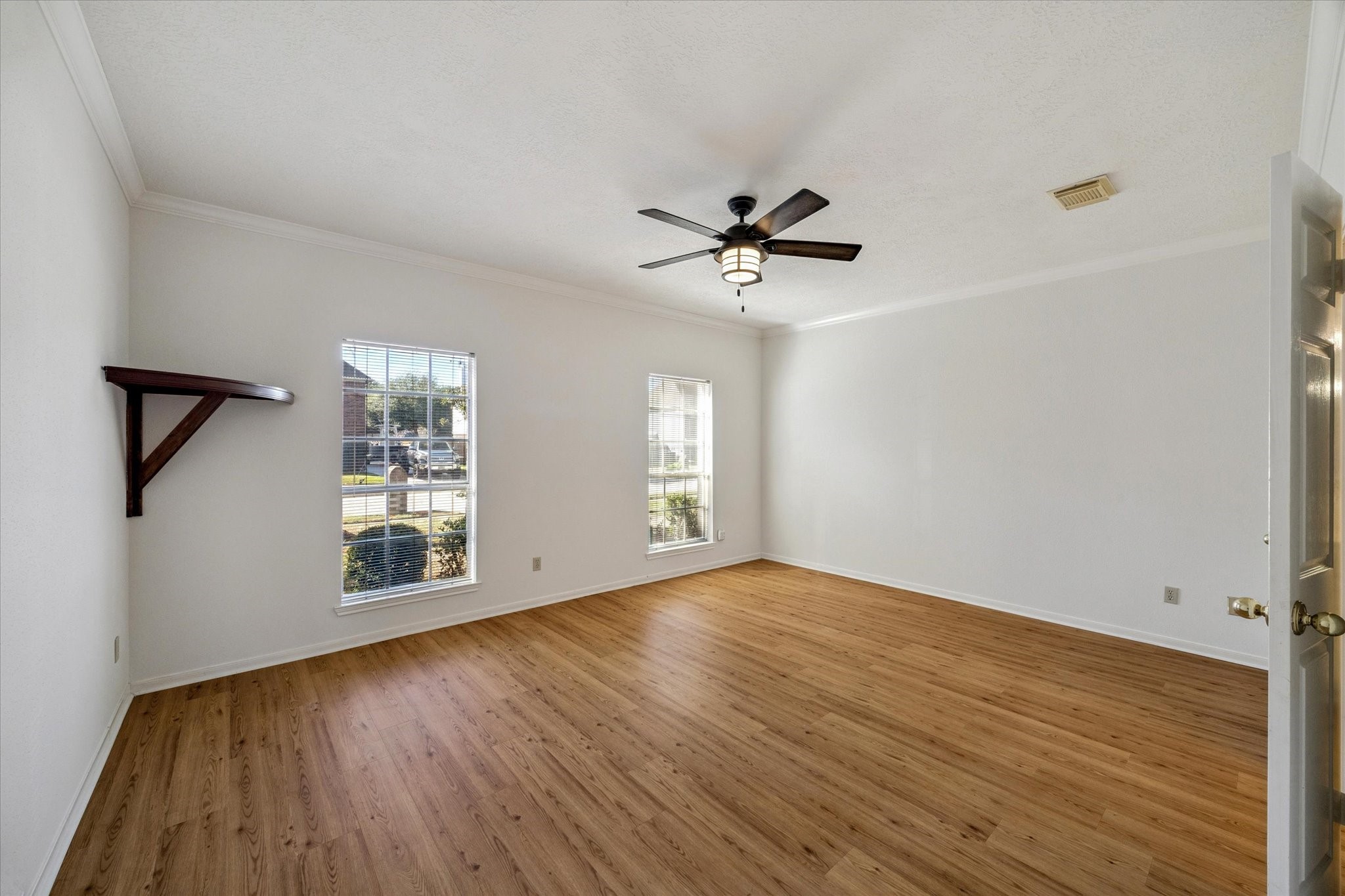 6523 Inverness Way Pasadena, TX 77505 - Photo 7 of 15 a view of an empty room with a window and wooden floor
