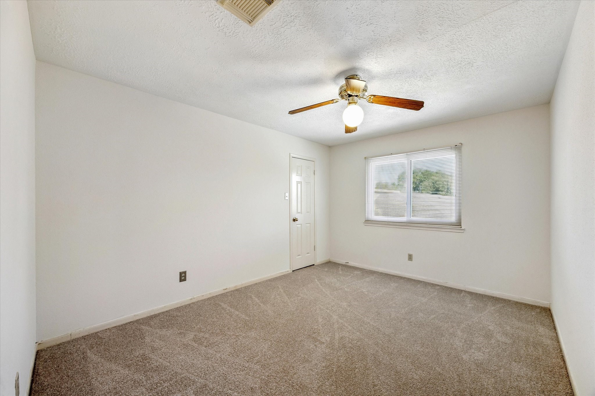 6523 Inverness Way Pasadena, TX 77505 - Photo 10 of 15 an empty room with chandelier fan and windows