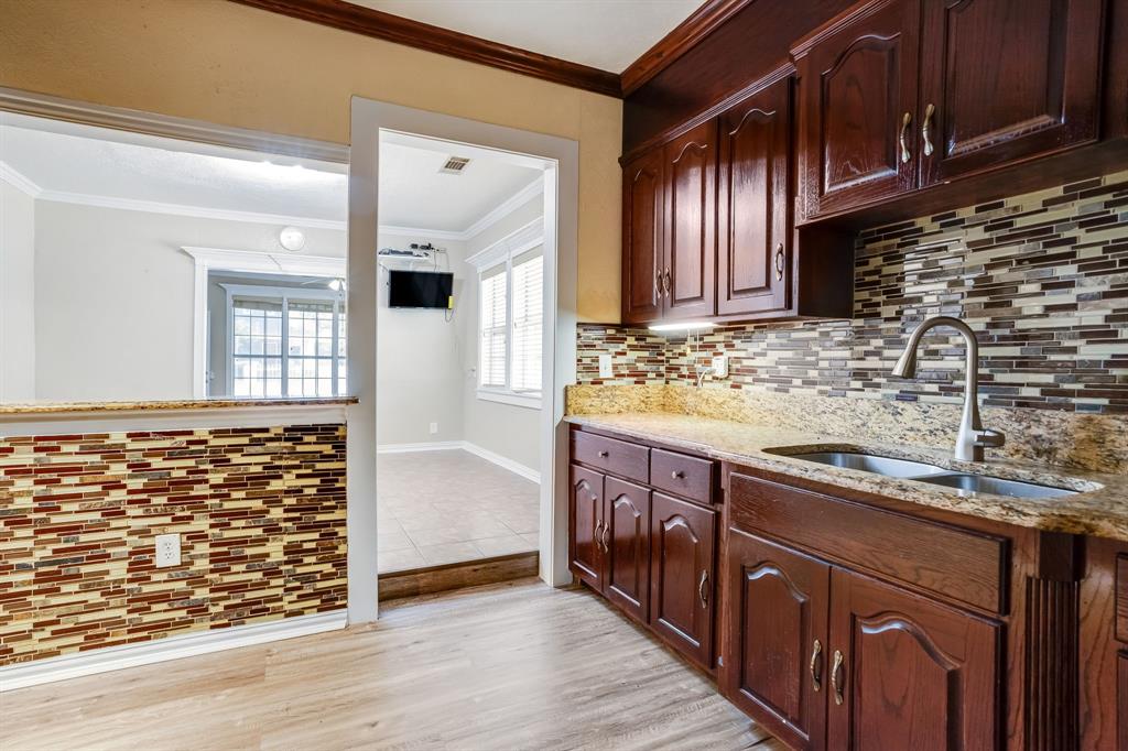 644 North Tyler Street Dallas, TX 75208 - Photo 13 of 33 a kitchen with stainless steel appliances granite countertop wooden cabinets a sink and dishwasher