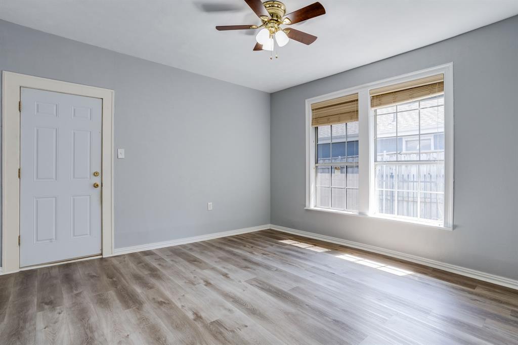 644 North Tyler Street Dallas, TX 75208 - Photo 15 of 33 a view of an empty room with a window and wooden floor