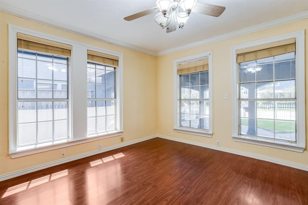 644 North Tyler Street Dallas, TX 75208 - Photo 17 of 33 a view of an empty room with a window and wooden floor