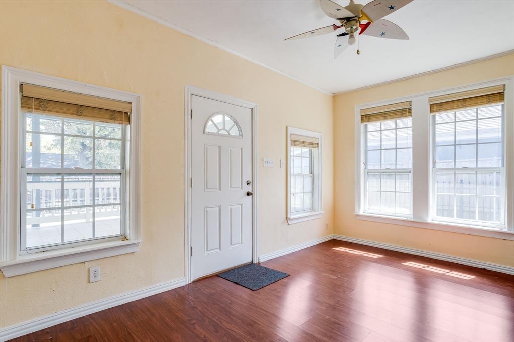 644 North Tyler Street Dallas, TX 75208 - Photo 19 of 33 a view of an empty room with a window and wooden floor