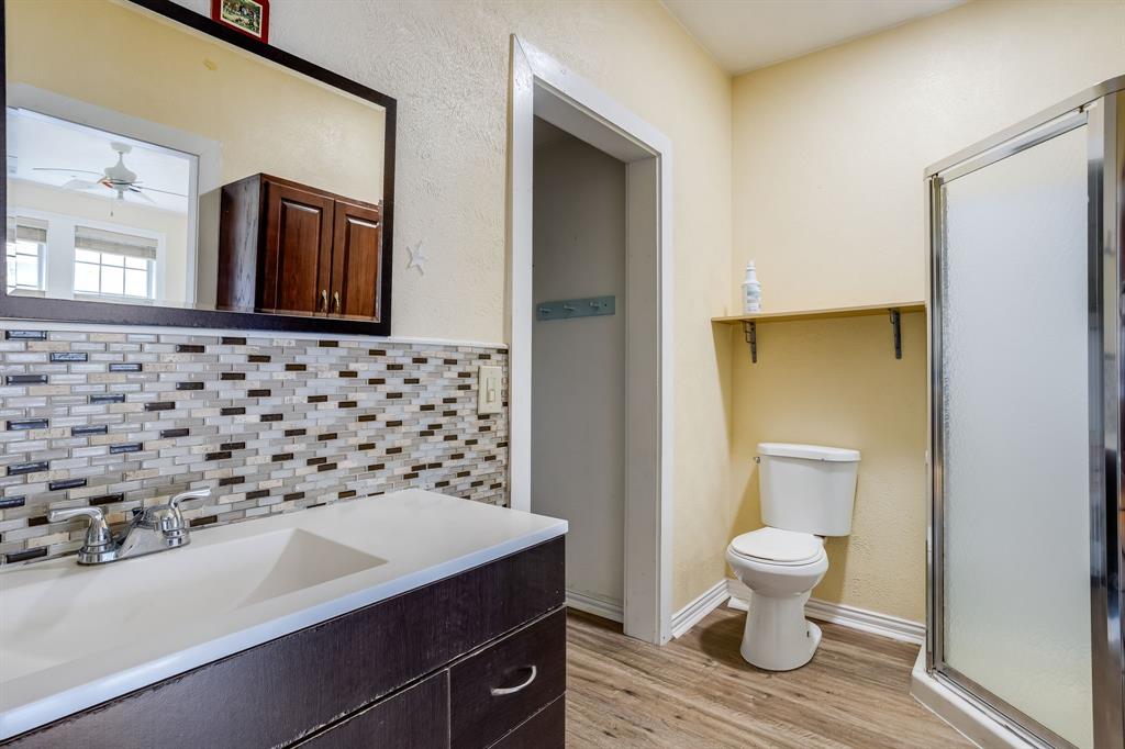 644 North Tyler Street Dallas, TX 75208 - Photo 21 of 33 a bathroom with a sink toilet and shower