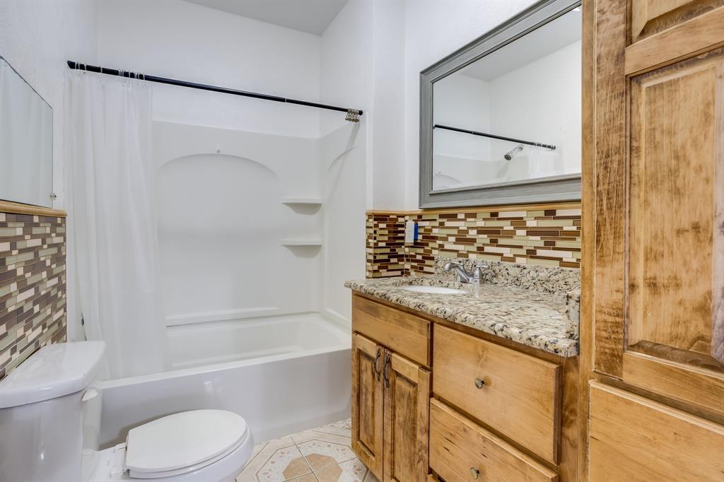 644 North Tyler Street Dallas, TX 75208 - Photo 22 of 33 a bathroom with a granite countertop sink toilet and shower