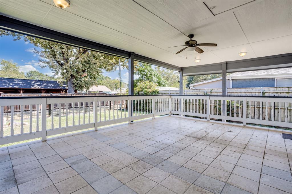 644 North Tyler Street Dallas, TX 75208 - Photo 23 of 33 a view of a porch with wooden floor and fence