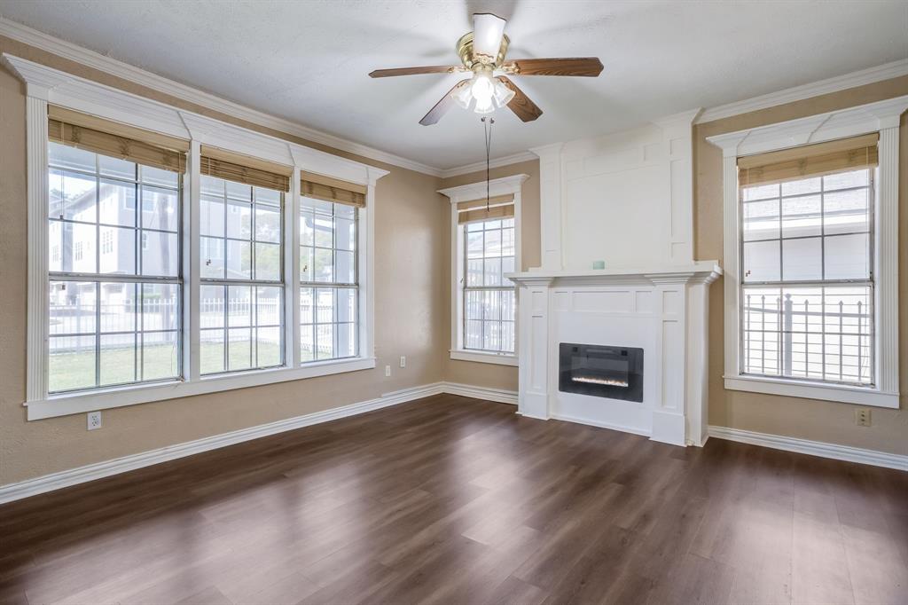 644 North Tyler Street Dallas, TX 75208 - Photo 6 of 33 a view of an empty room with wooden floor and a window