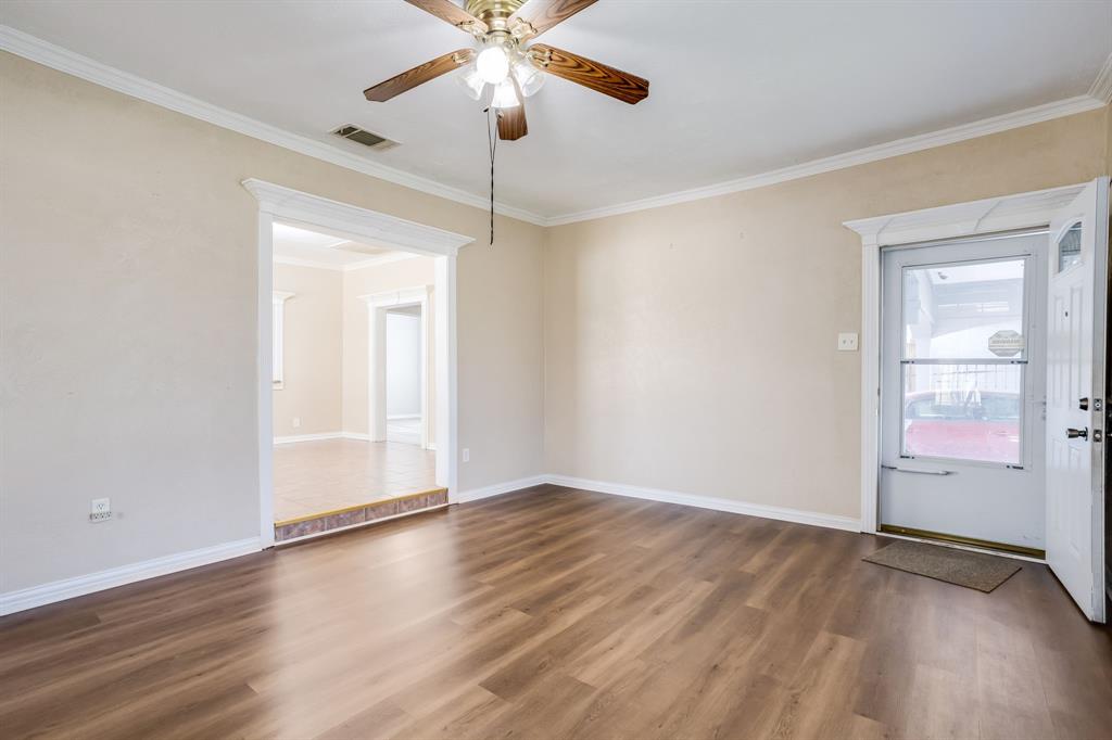 644 North Tyler Street Dallas, TX 75208 - Photo 7 of 33 an empty room with wooden floor fan and windows