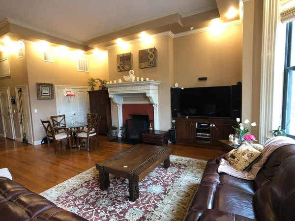 a living room with furniture a flat screen tv and a fireplace