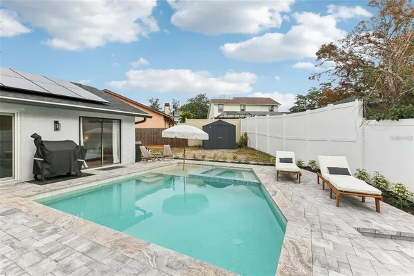 a swimming pool with outdoor seating
