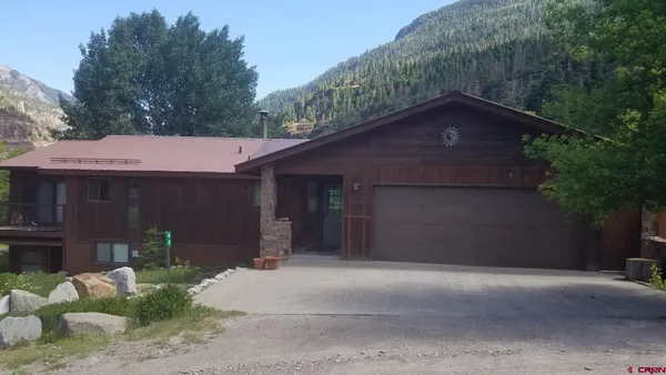 a house with a tree in front of it