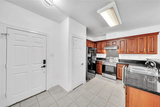 a kitchen with stainless steel appliances granite countertop a refrigerator stove and sink