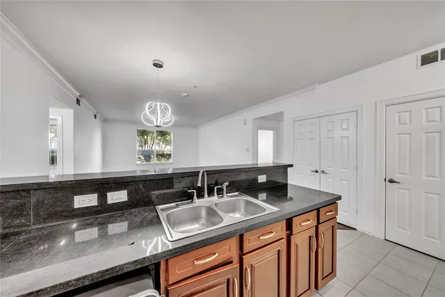 a kitchen with granite countertop a sink and a cabinets