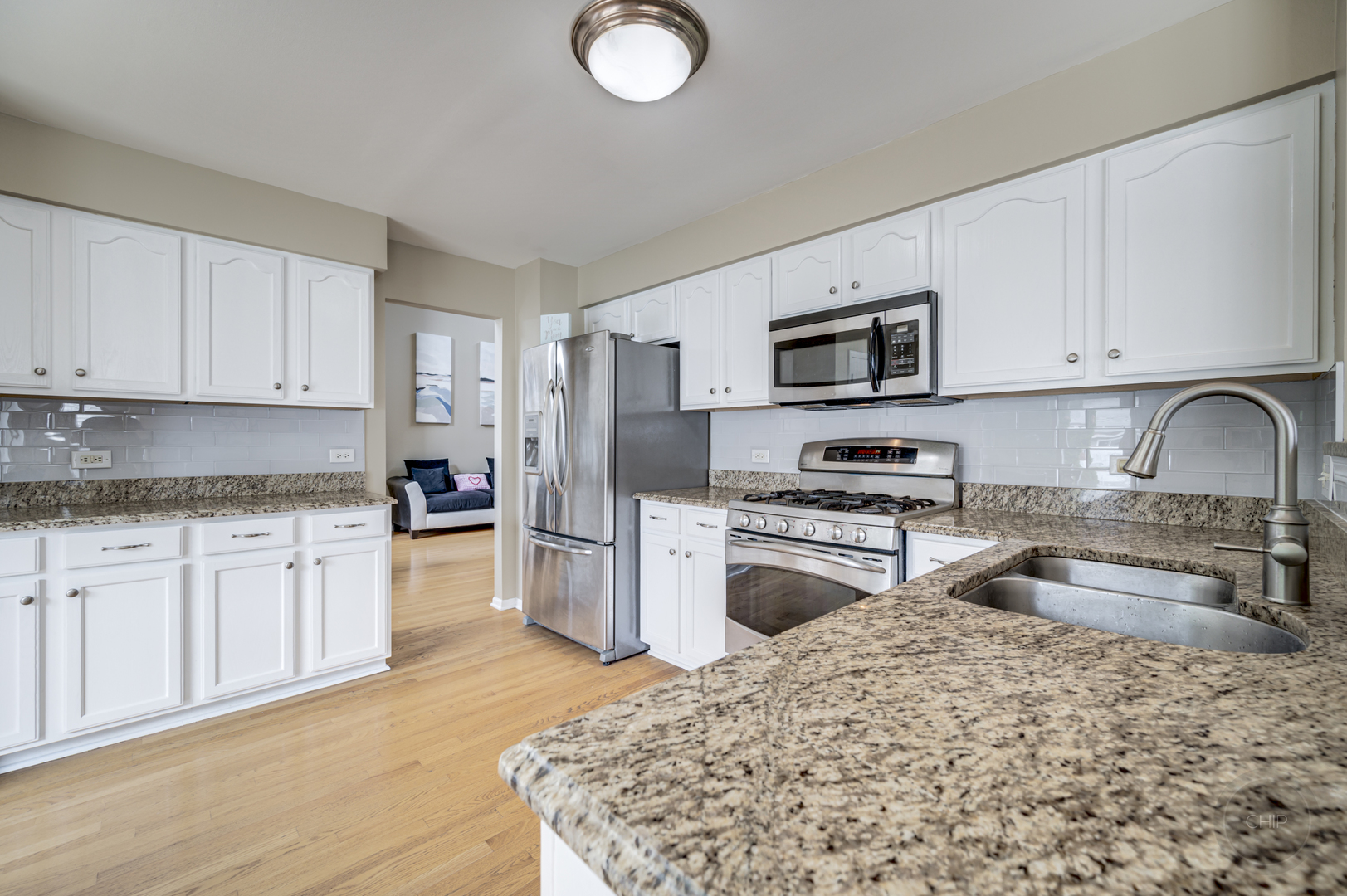 2135 Skylane Drive Naperville, IL 60564 - Photo 13 of 44 a kitchen with granite countertop a sink stove and refrigerator