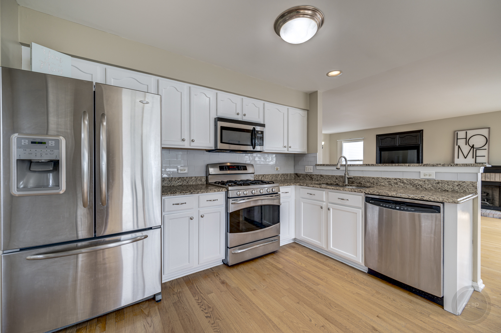 2135 Skylane Drive Naperville, IL 60564 - Photo 14 of 44 a kitchen with granite countertop a refrigerator stove and microwave