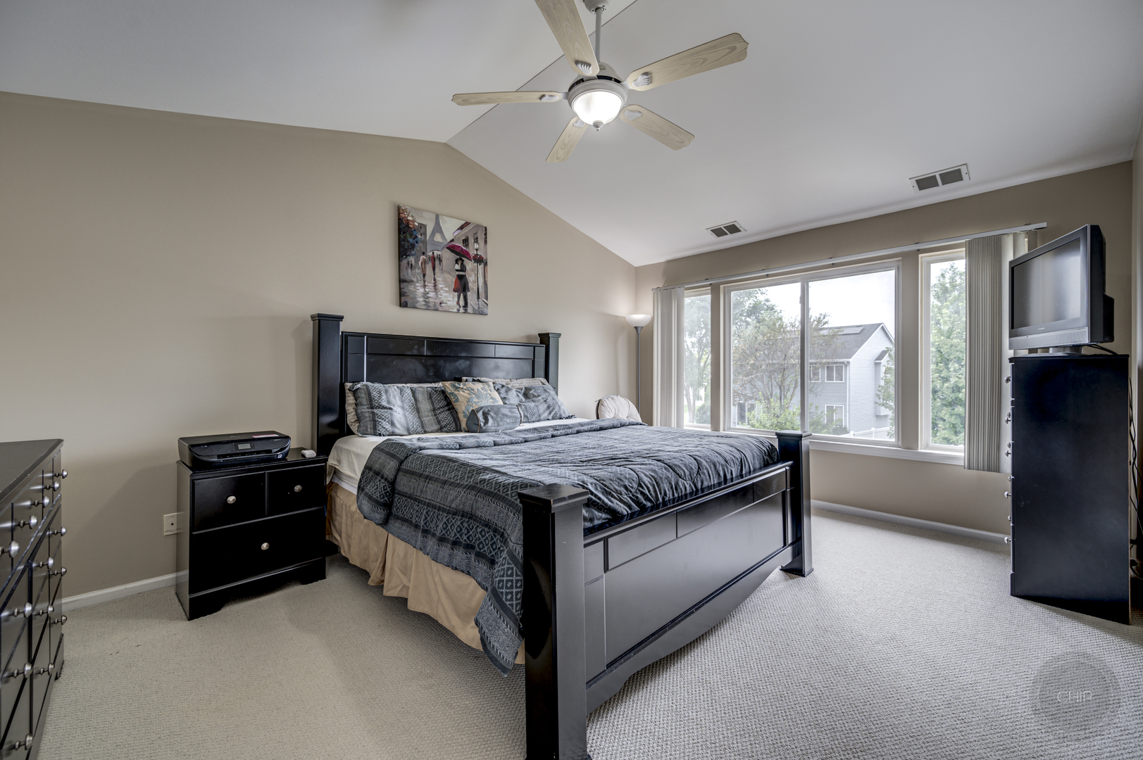 2135 Skylane Drive Naperville, IL 60564 - Photo 20 of 44 a bedroom with a bed and a large window with a projector