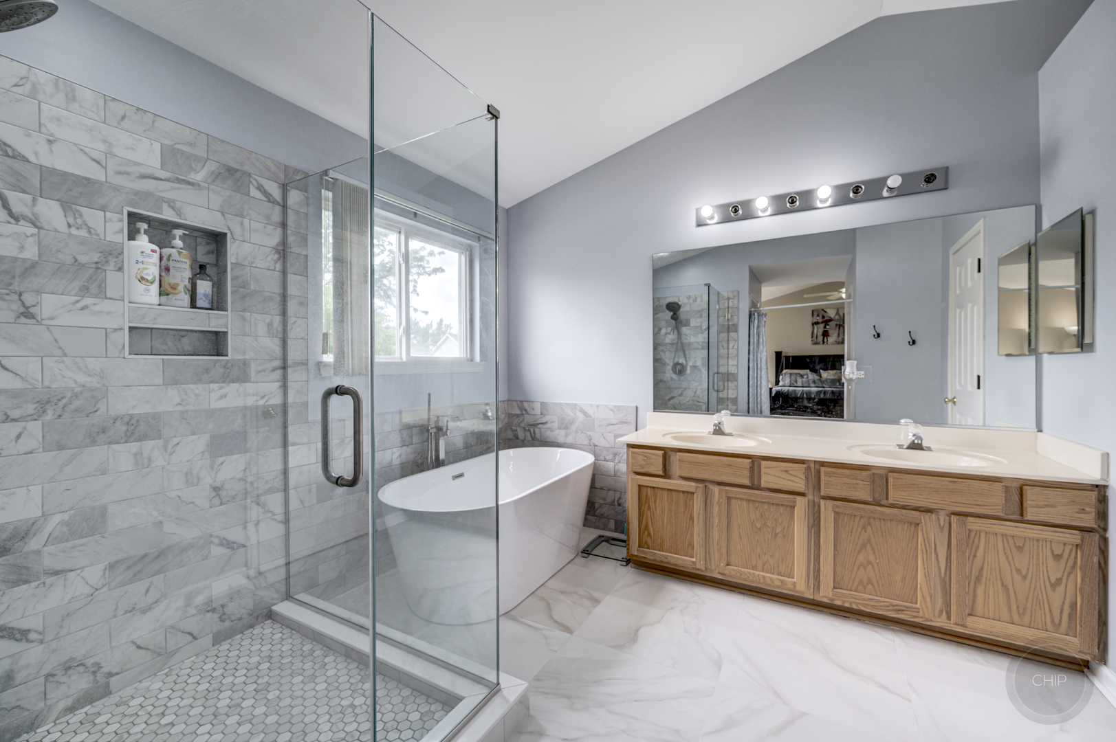 2135 Skylane Drive Naperville, IL 60564 - Photo 24 of 44 a bathroom with a double vanity sink a toilet a mirror and shower