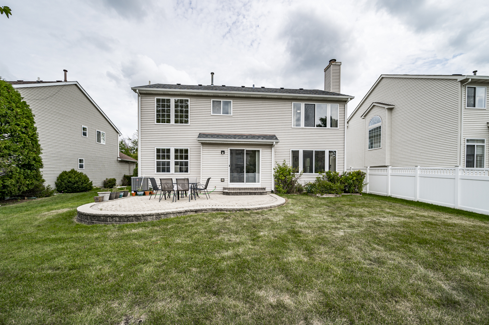 2135 Skylane Drive Naperville, IL 60564 - Photo 41 of 44 a front view of a house with a yard table and chairs
