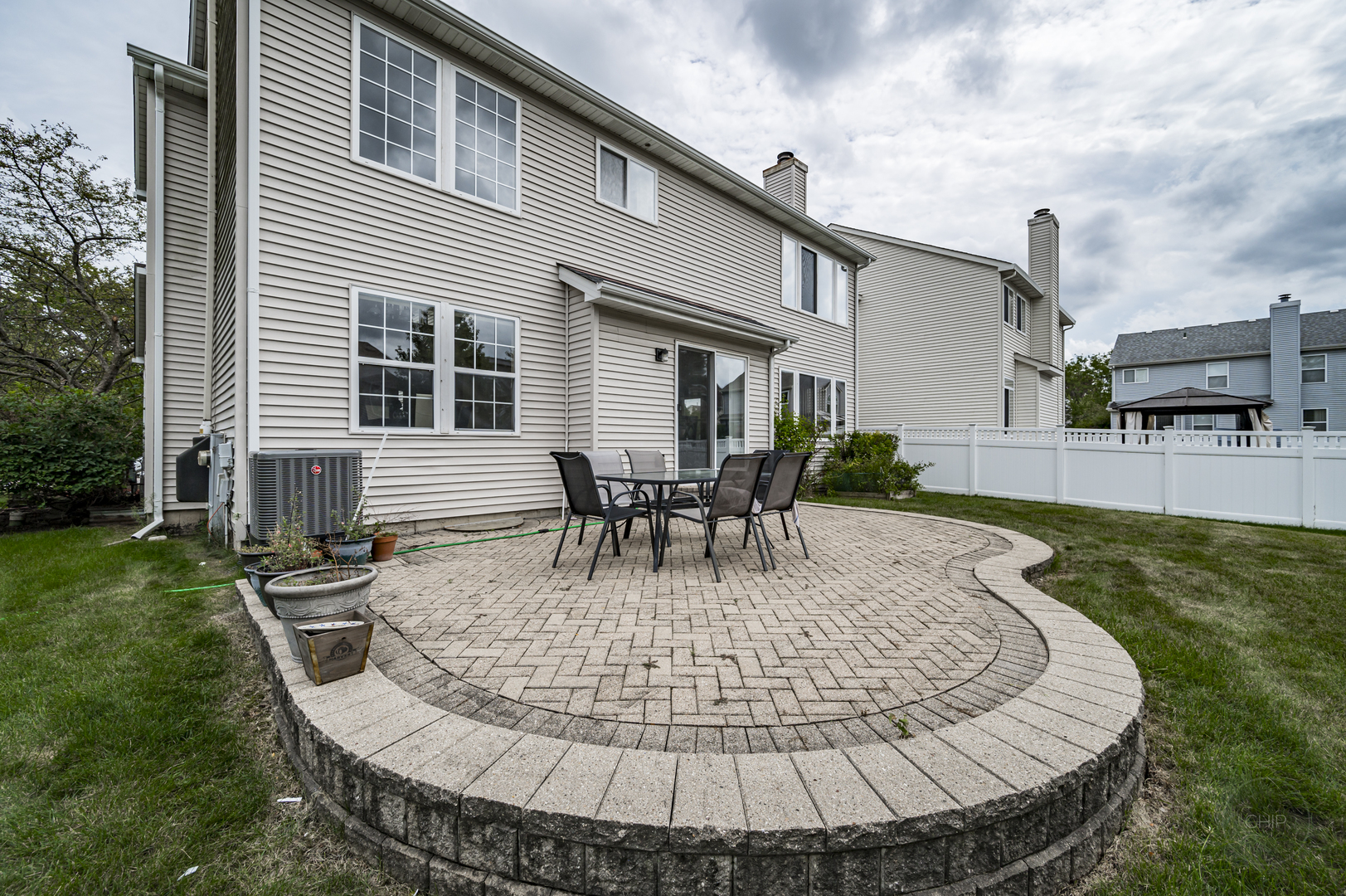 2135 Skylane Drive Naperville, IL 60564 - Photo 43 of 44 a view of a house with backyard sitting area and garden