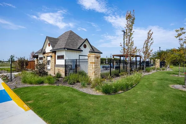 a front view of a house with a yard table and chairs