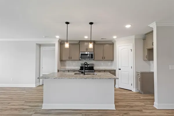 a view of a kitchen with a sink and a refrigerator