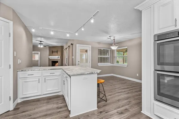 a kitchen with stainless steel appliances granite countertop a stove refrigerator sink and microwave