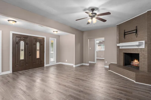 wooden floor in an empty room with a window
