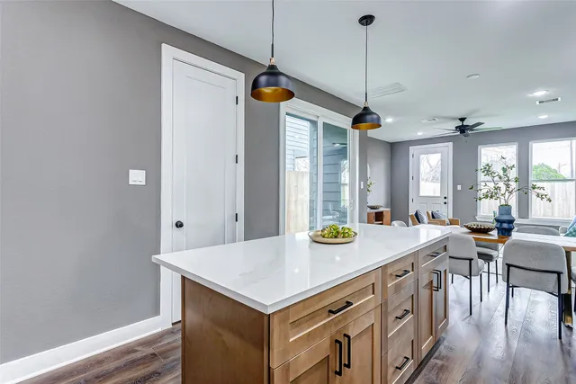 a kitchen that has a kitchen island wooden floor and a window