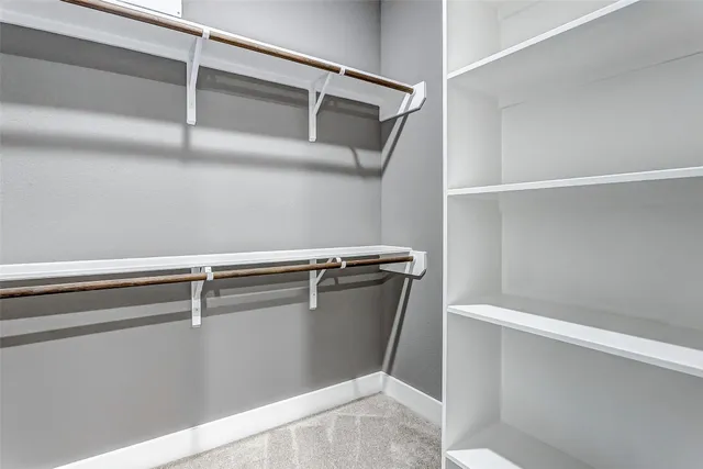 a bedroom with a bed and windows