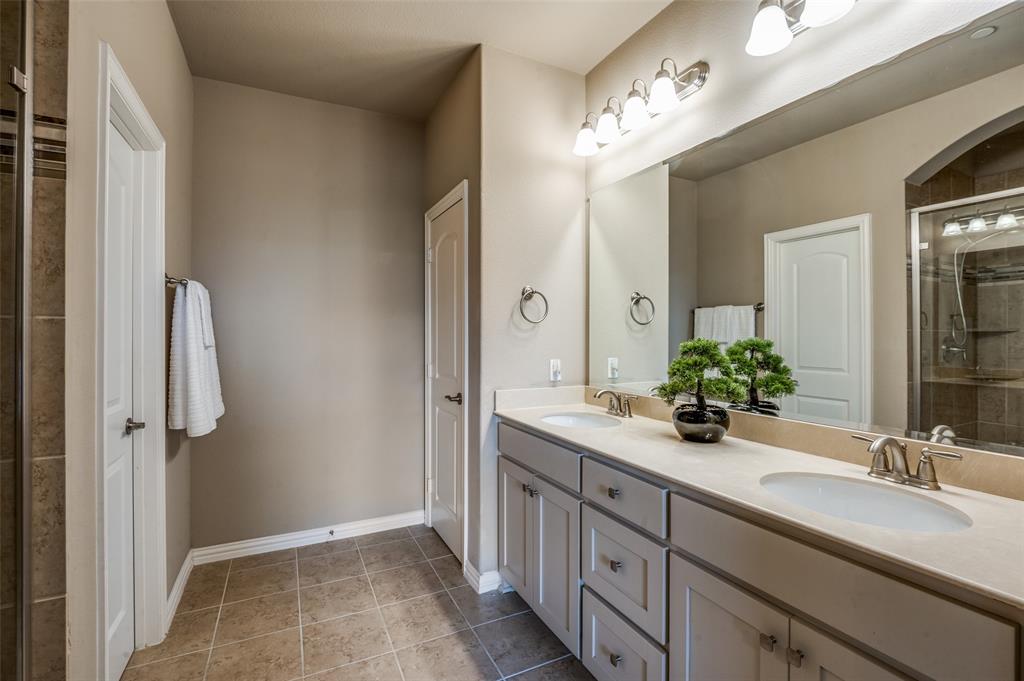 4665 Dozier Road, Unit C Carrollton, TX 75010 - Photo 13 of 26 a bathroom with a double vanity sink and a mirror