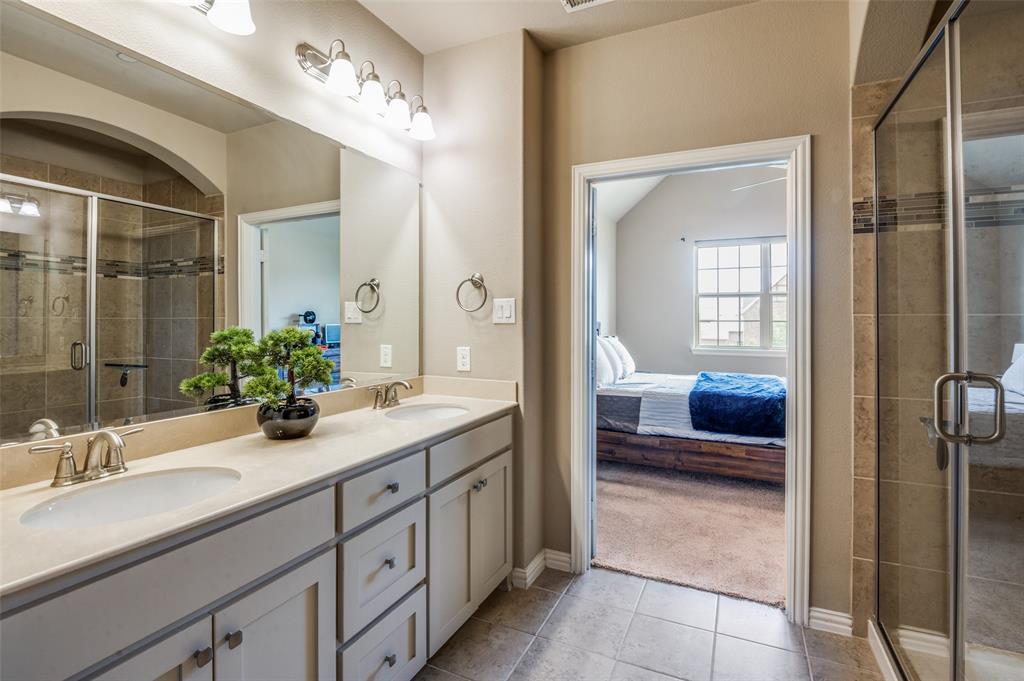 4665 Dozier Road, Unit C Carrollton, TX 75010 - Photo 14 of 26 a spacious en suite bathroom with a double sink and mirror