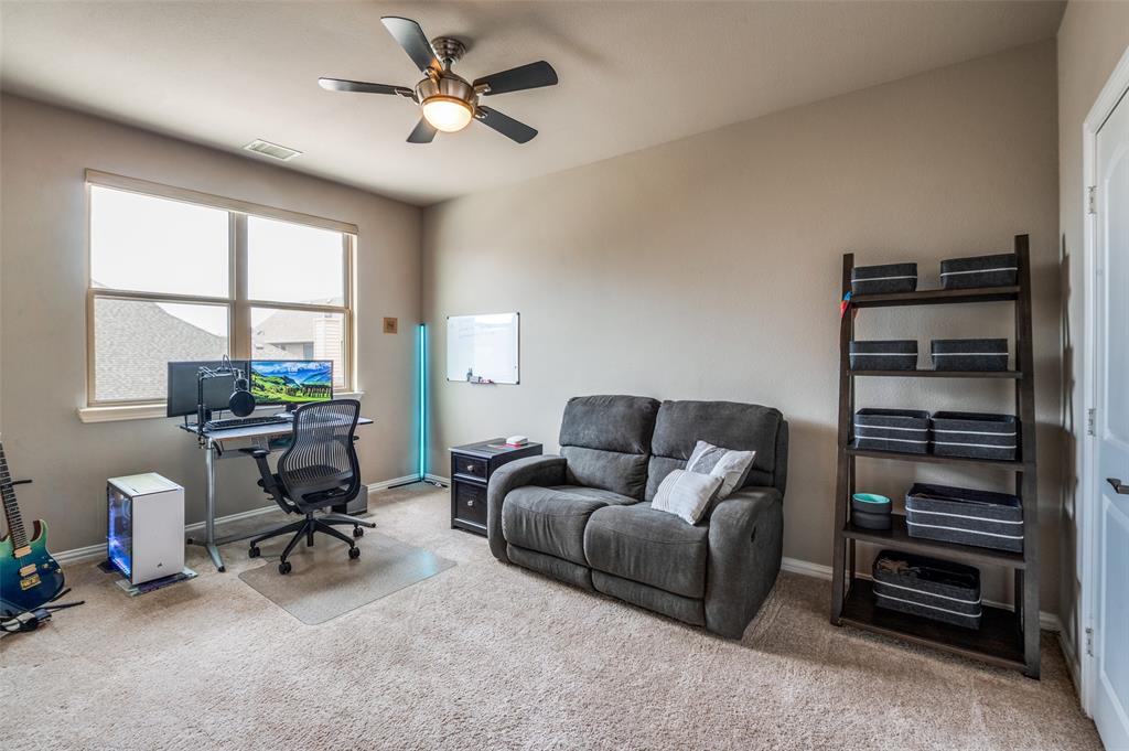 4665 Dozier Road, Unit C Carrollton, TX 75010 - Photo 16 of 26 a living room with furniture a ceiling fan and a window