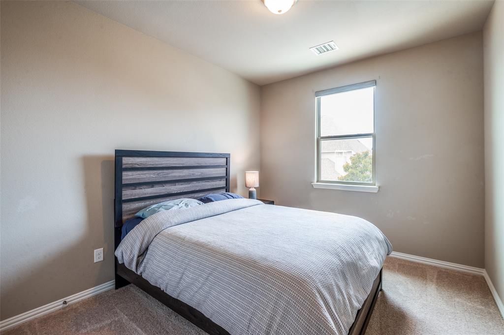 4665 Dozier Road, Unit C Carrollton, TX 75010 - Photo 18 of 26 a bedroom with a bed and a window