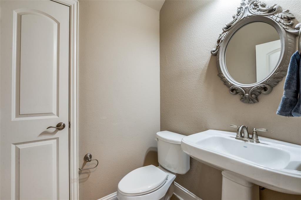 4665 Dozier Road, Unit C Carrollton, TX 75010 - Photo 8 of 26 a bathroom with a granite countertop toilet a sink and mirror
