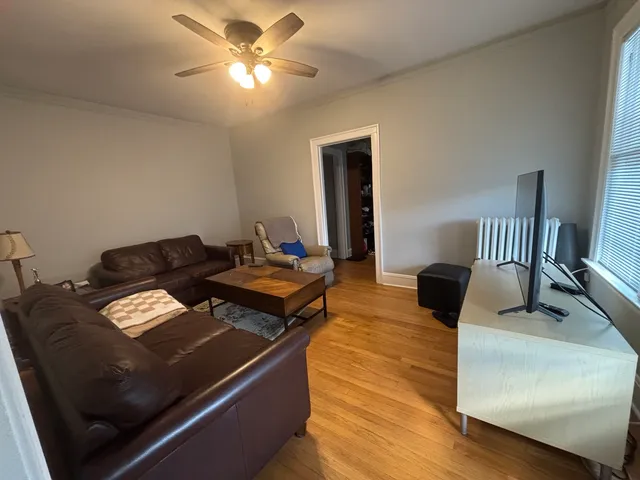 a living room with furniture and a lamp