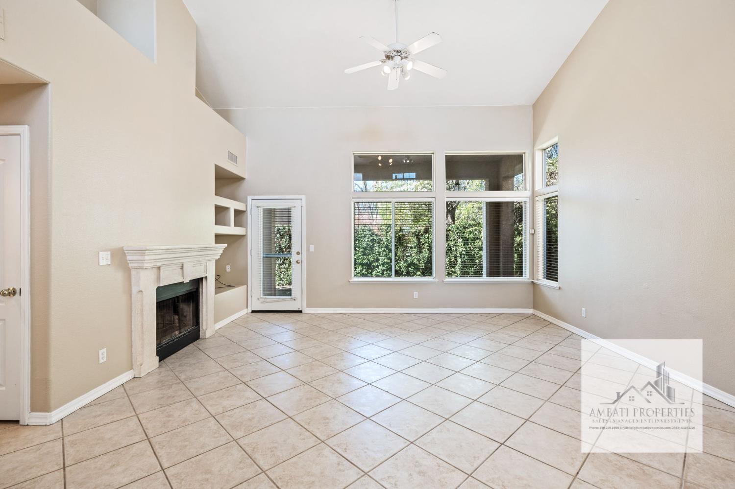 7577 North Trellis Circle Fresno, CA 93720 - Photo 3 of 11 a view of an empty room with a fireplace and a window