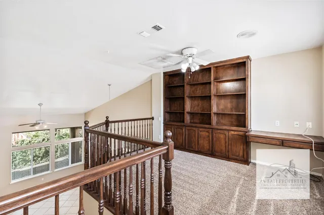 a view of a hallway with furniture