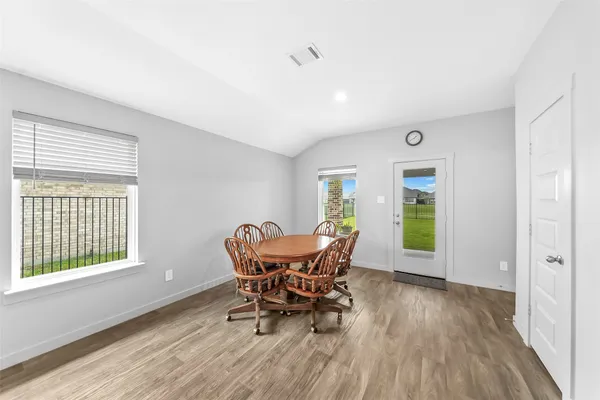a dining room with furniture and windows