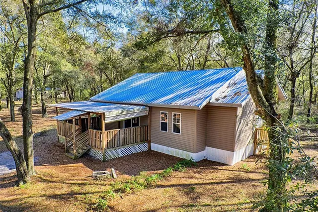 a view of house with backyard