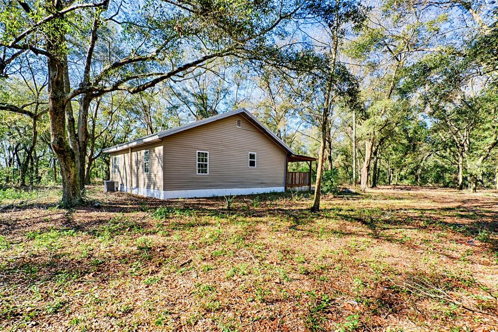 300 South Us Highway Bell, FL 32619 - Photo 20 of 47 a house with trees in the background